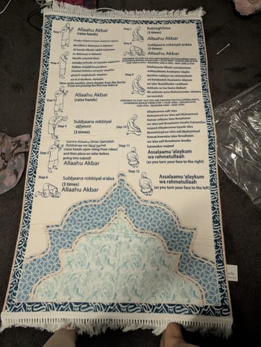 Customer's visual padded prayer mat laid out, showing the step-by-step illustrations for learning Salah.