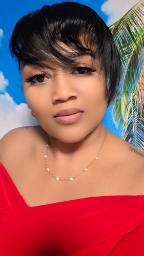 Reviewer wearing an elegant pearl necklace from the Waterproof Jewelry Bundle.