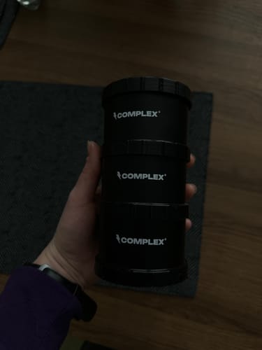 A customer holds the three-section black Powder Tower in their hand.