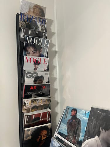 Reviewer's VOGUE JAPAN magazine displayed in a black rack as part of their larger BTS V collection.