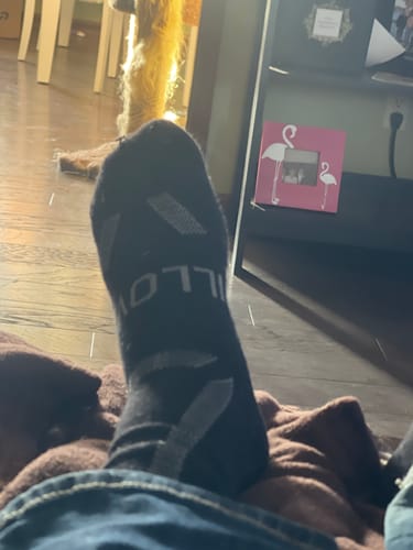 Reviewer's close-up view of their foot wearing the black Men's Alpaca Socks.