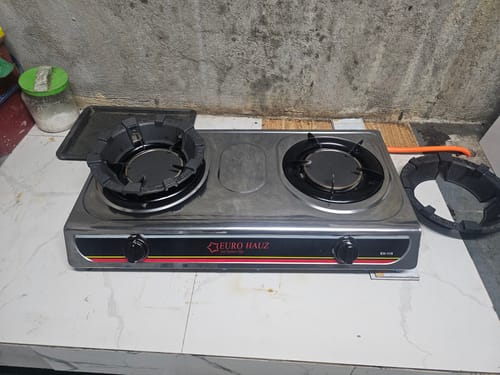 Customer's stainless steel Eurohauz Infrared Gas Stove on a white marbled countertop, with one burner cover sitting beside it.