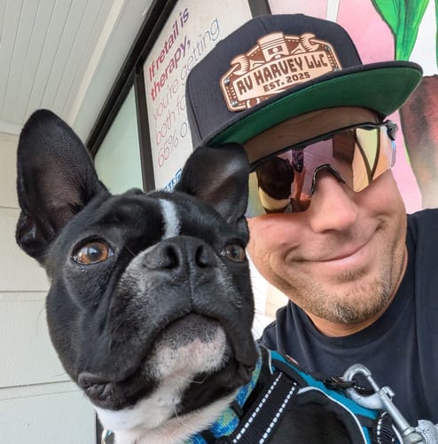 Reviewer wearing a black Work Hat Mechanic with a flat green bill and a custom leather patch.