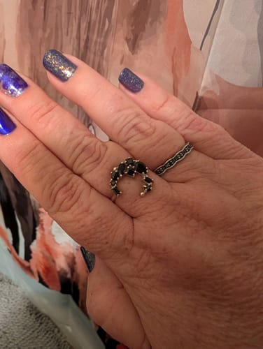 Customer's hand wearing the beautiful Black Onyx Moon Ring on the middle finger.