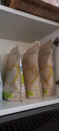 Customer's three bags of Superblend Protein Powder stocked in a supplement cupboard.