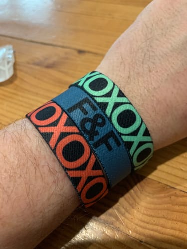 Customer showing how they stack three different colored F&F Colorwheel Bracelets on their wrist.