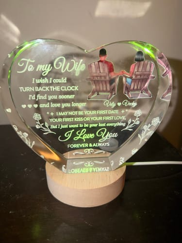 Customer's personalized Crystal Heart LED gift lit with a soft green glow on its wooden base.