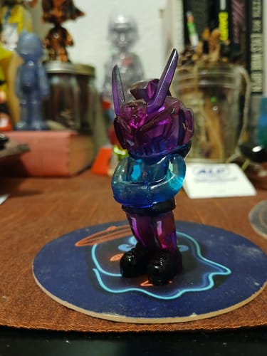 Customer's translucent Oil Slick Micro TEQ63 figure showing its purple to blue gradient on a desk.