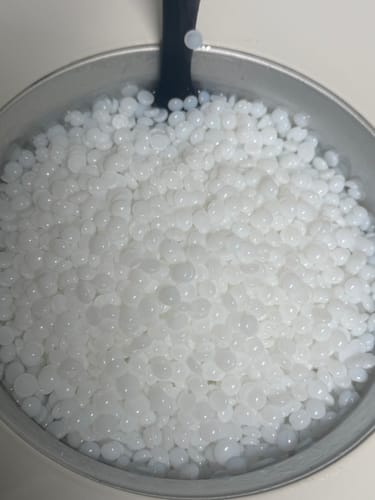 Customer's close-up of White Coral Wax beads in a metal pot.