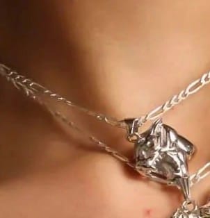 Close-up of a customer wearing the HELLCAT PENDANT on a silver chain around their neck.