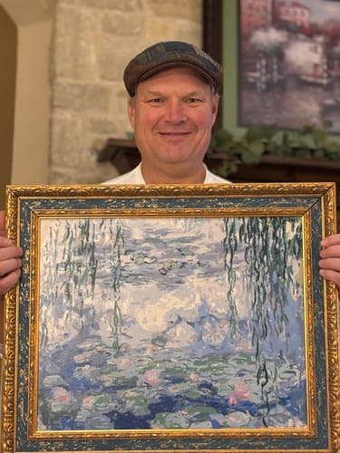 Reviewer holding the finished and framed Water Lilies, Nympheas (1916) paint by numbers artwork.