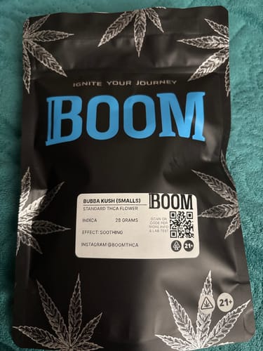 Customer's black pouch packaging for Bubba Kush Smalls (Oz) shown on a textured surface.