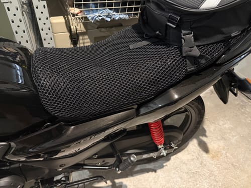 Customer's black mesh Wind Rider Seat Cover installed on a motorcycle, showing its textured fit.