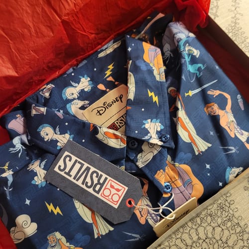 Customer's Disney's Hercules "Grecian Gallery" shirt folded neatly in a gift box with red tissue.