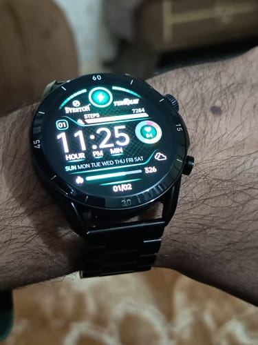 Customer's black Torque Chain Smartwatch on their wrist, showing the digital display and stainless steel band.