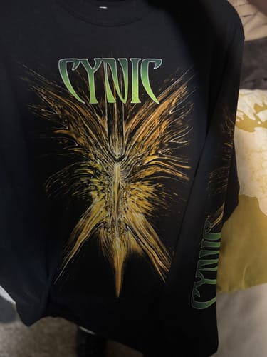 Customer's black Cynic longsleeve shirt, showing the vivid 'Focus' graphic on the front and logo on the sleeve.
