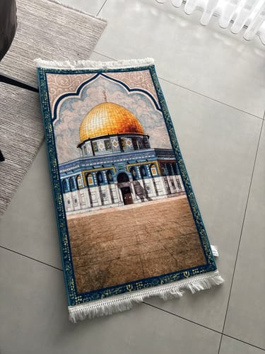Customer's Al Aqsa WaterColour Padded Prayer Mat laid on a tile floor, showing its beautiful mosque design.