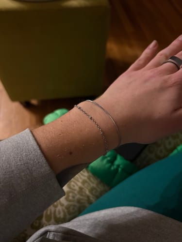 Reviewer's close-up of the delicate Pia Silver Layered Bracelet on their wrist.
