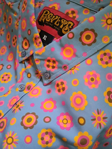 Customer's close-up photo of the Flower Ballad shirt, showing the colorful retro floral pattern on the collar and placket.