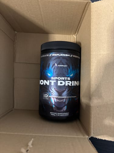 A customer's black tub of Sports Iont Drink, with a tiger graphic, sitting inside a cardboard shipping box.