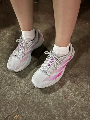 Customer wearing the grey and lucid fuchsia adidas Adizero EVO SL Running Shoes.
