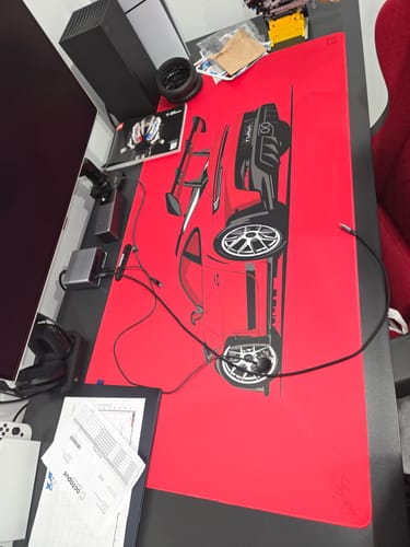 Reviewer's bright red 992 RS Indischrot desk mat with a car graphic on a desk setup.