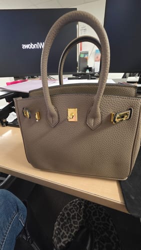 Customer's structured, pebbled Warkin Bag with gold hardware sitting on a desk.