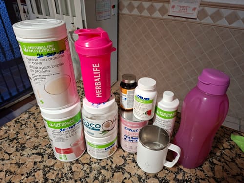 Foto de cliente del Té Matcha con Colágeno junto a otros suplementos alimentarios en una encimera de cocina.