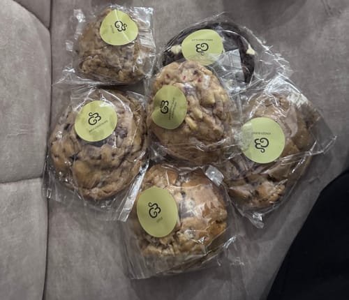 Customer's six assorted cookies from the selection box, individually wrapped in clear packaging.