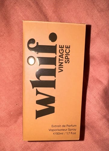 Customer's box of Vintage Spice perfume resting on a pink textured fabric.