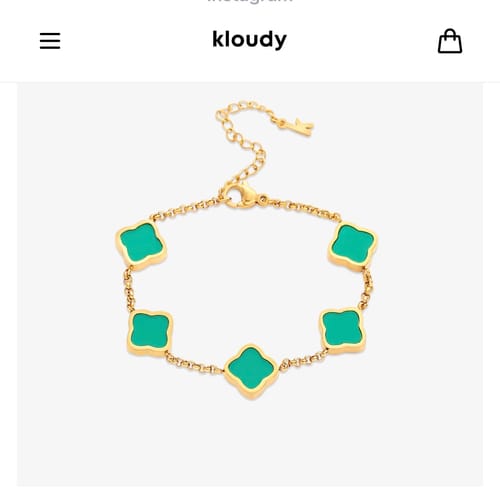 Customer's beautiful Celine Clover Bracelet with a gold chain and five green clover motifs.