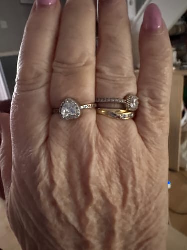 A reviewer's hand wearing the heart-shaped Forever In My Heart Urn Ring on their middle finger.