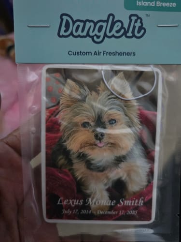 Reviewer's memorial custom air freshener in its packaging, featuring a photo of their pet Yorkie.