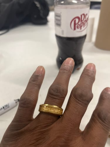 Customer wearing the gold Aureum ring, showing a close-up of the textured inlay.