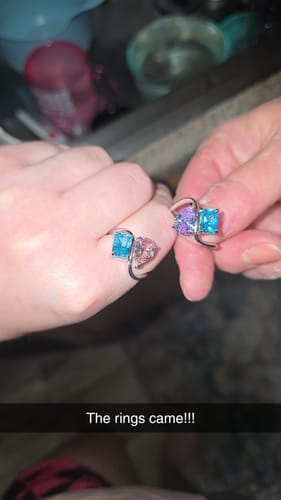 Customer compares two Navae Birthstone Rings, one worn and one held, showcasing different colorful gemstone combinations.