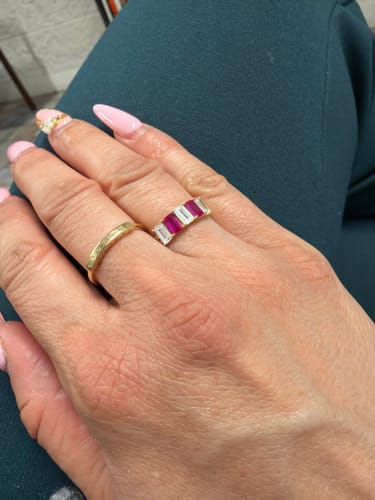 A customer's hand wearing the 14k Red & White CZ Women’s Ring on their finger.