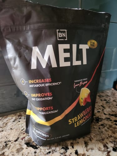 Reviewer's black pouch of Stim-Free Melt in Strawberry Lemonade flavor on a kitchen counter.
