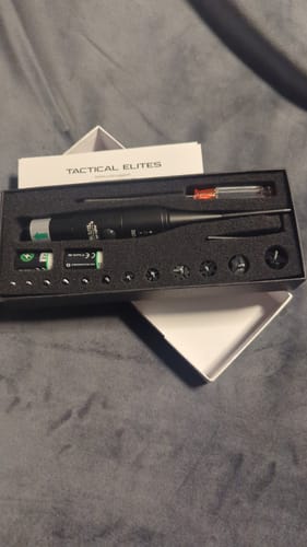 Customer's Site Right™ 2.0 Boresighter kit in its open case, showing the main tool, batteries, and assorted caliber parts.
