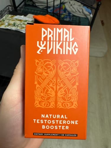 Customer holding the orange box of Primal Viking Natural Testosterone Booster.
