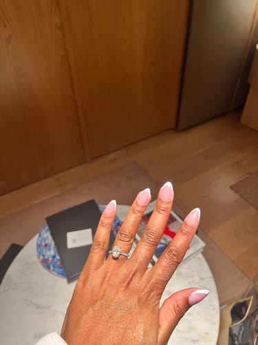 Customer's hand showing the applied French Fancy Press On Nails in a classic almond shape.
