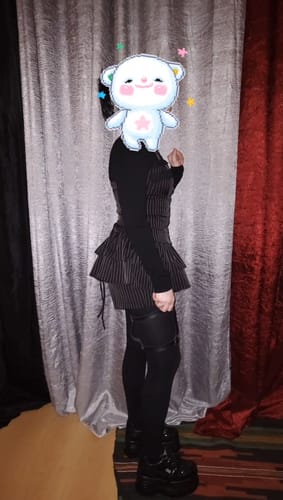 Reviewer shows a side view of the pinstripe Grunge Doll Stripes Flared Romper Dress, highlighting the flared fit.