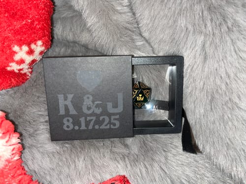 Customer's personalized black box for the Custom Anniversary D20 Dice, showing the die in its display window.