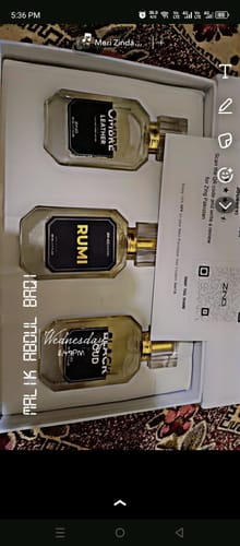 Customer's open Winter Box showing the Rumi, Ombre Leather, and Black Oud fragrance bottles arranged inside.