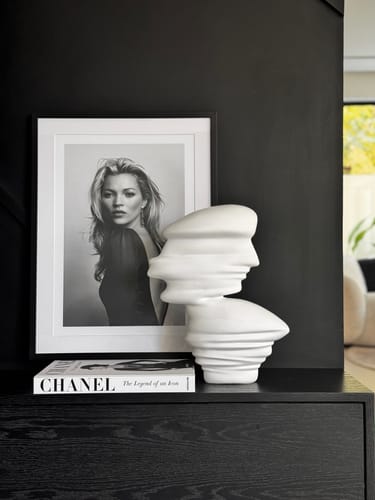 Reviewer's white abstract sculpture displayed on a black console as a modern statement piece.