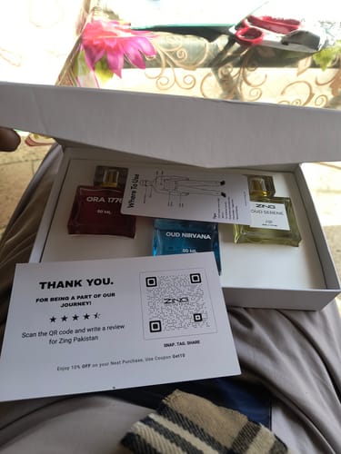 Customer's OUD Supreme BUNDLE with three perfume bottles displayed in their open white box.