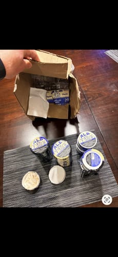 Customer shows a crushed box and mostly intact cans of Chilled Mint Nicotine Pouches after being run over by a car.