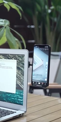 Customer's black MagPro Magnetic Phone Holder attached to a laptop, holding a smartphone vertically.