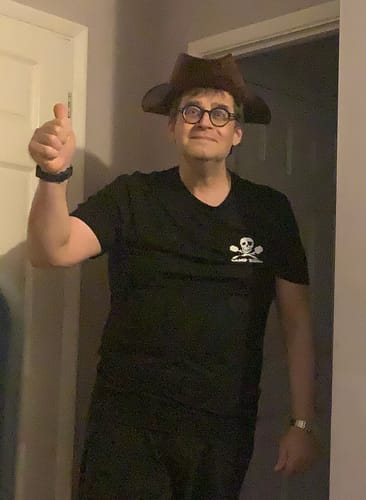 Reviewer wearing the black Camp Kunu – Crewneck Tee as part of a fun pirate costume, giving a thumbs-up.