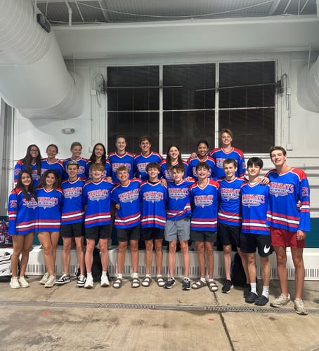 A reviewer's swim team posing together in their new custom blue and red jerseys.