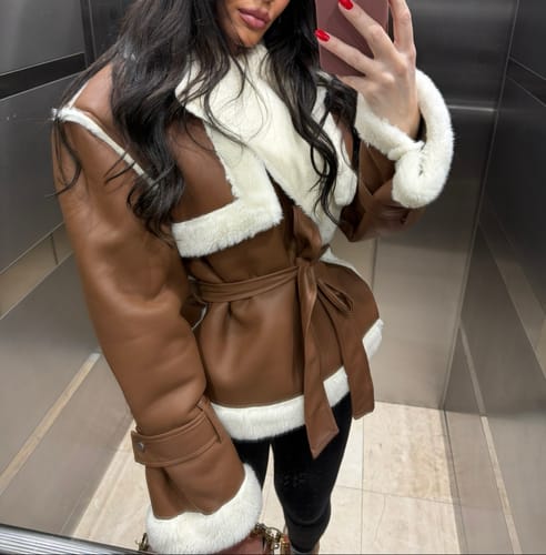 Reviewer wearing the brown Vegan Leather Sherpa Coat with plush sherpa trim, tied at the waist.